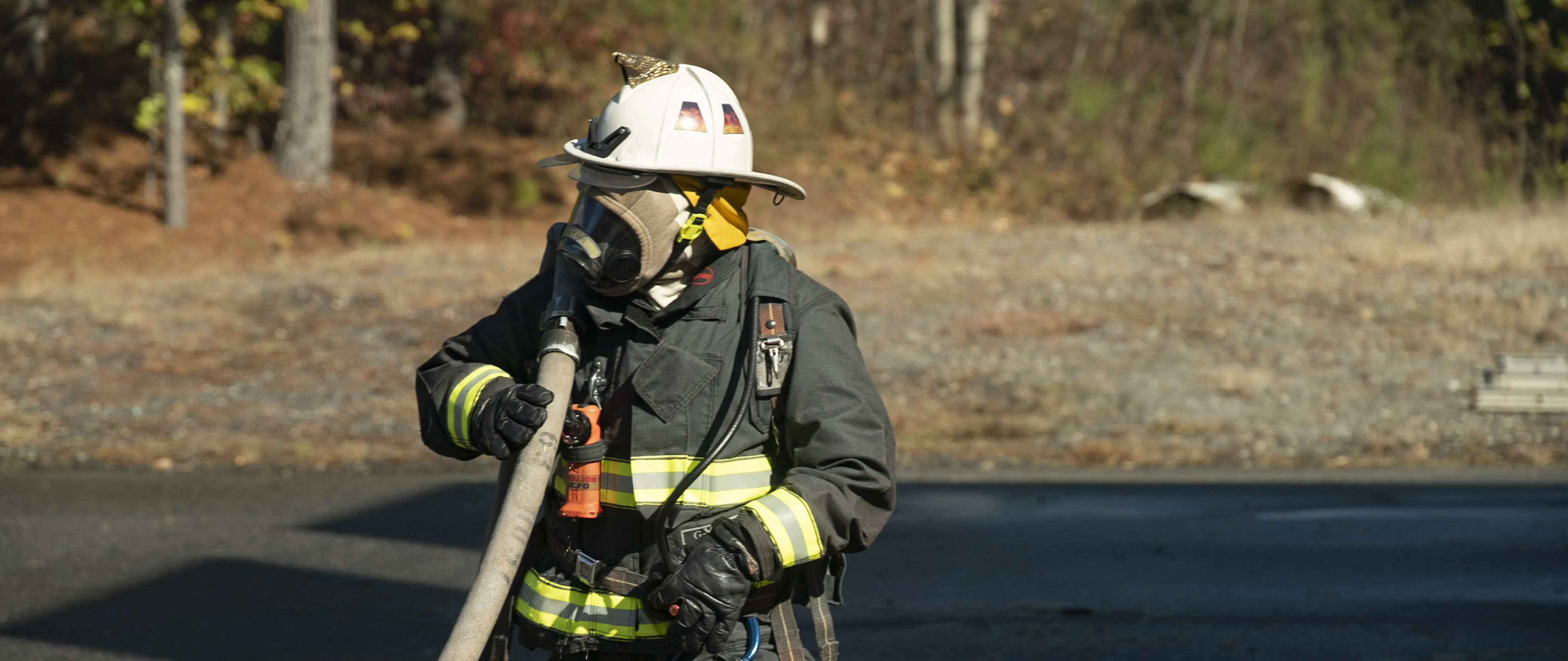 Firefighter carrying a hose