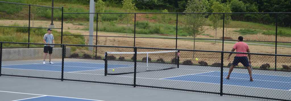 Two men playing pickleball at Cauley Creek Park