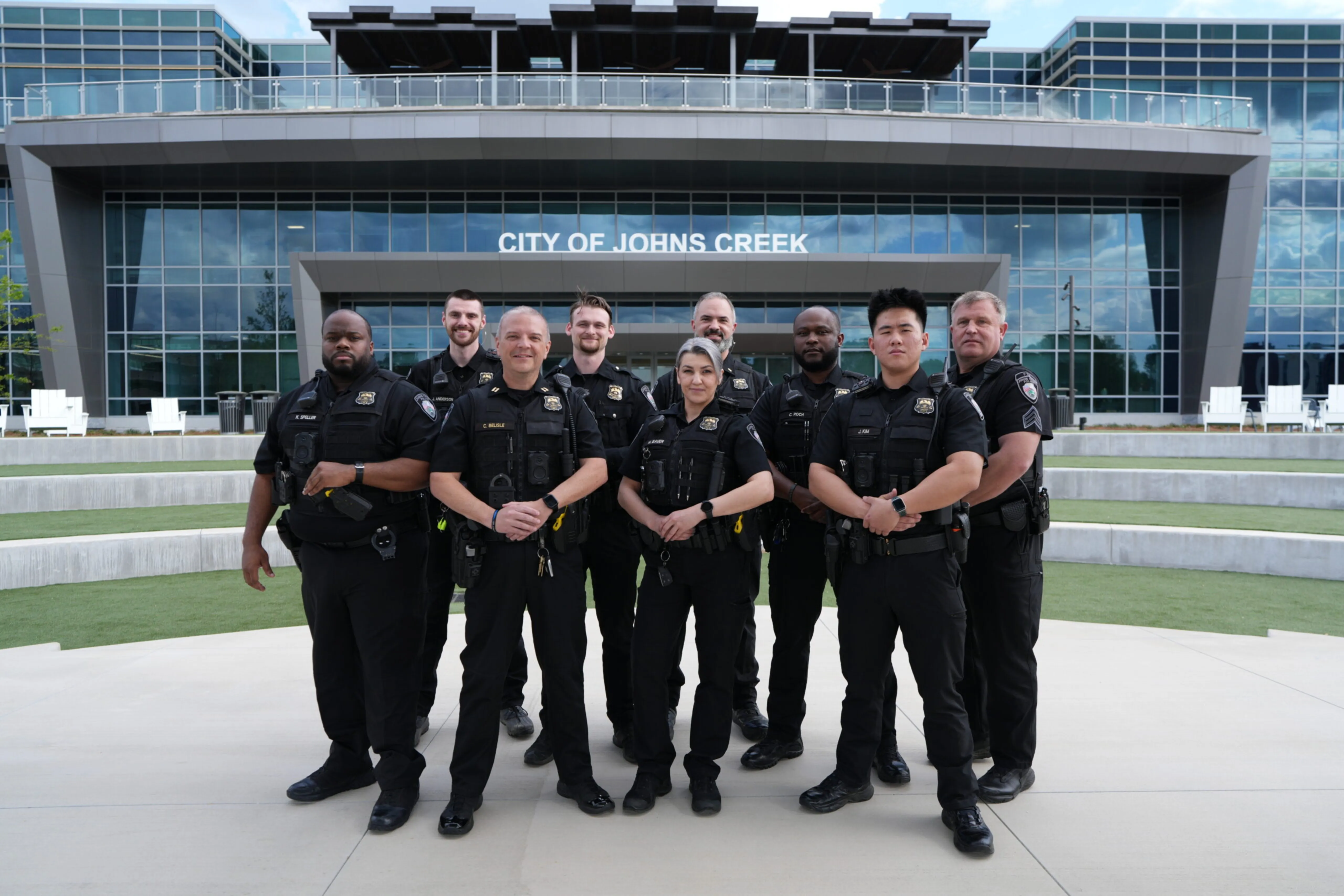 A group of police officers standing in front of City Hall.